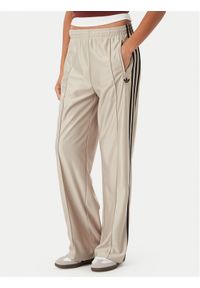 Adidas - adidas Spodnie dresowe Metallic Firebird KS9974 Beżowy Wide Leg. Kolor: beżowy. Materiał: syntetyk #1