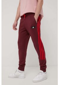 adidas Performance spodnie HC5262 męskie kolor bordowy z aplikacją. Kolor: czerwony. Materiał: bawełna. Wzór: aplikacja