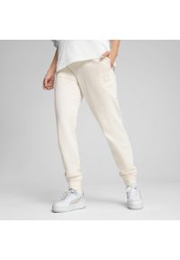 Puma - Damskie spodnie dresowe ESS ELEVATED PUMA No Dye Color Mix. Materiał: dresówka. Sport: turystyka piesza