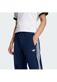 Adidas - adidas Spodnie dresowe Firebird KD8316 Granatowy Loose Fit. Kolor: niebieski. Materiał: syntetyk #3
