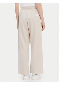 TOMMY HILFIGER - Tommy Hilfiger Spodnie dresowe UW0UW04771 Beżowy Relaxed Fit. Kolor: beżowy. Materiał: dresówka #5