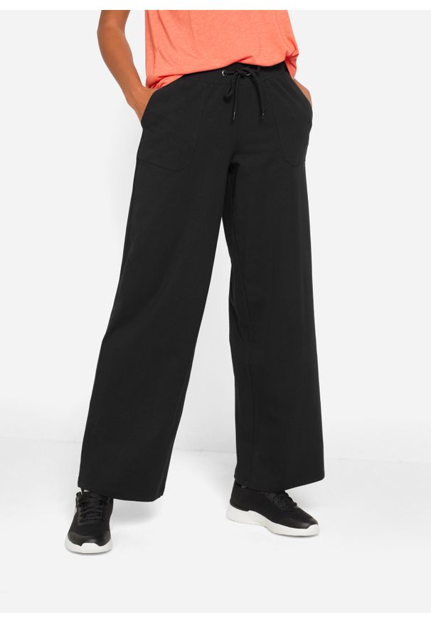 bonprix - Spodnie sportowe bawełniane, szerokie nogawki. Kolor: czarny. Materiał: bawełna. Styl: sportowy