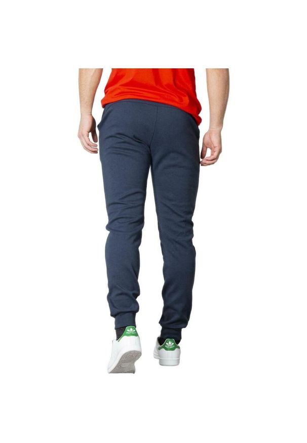Spodnie Le Coq Sportif Essential, Mężczyźni. Kolor: niebieski. Materiał: poliester, bawełna. Sport: fitness