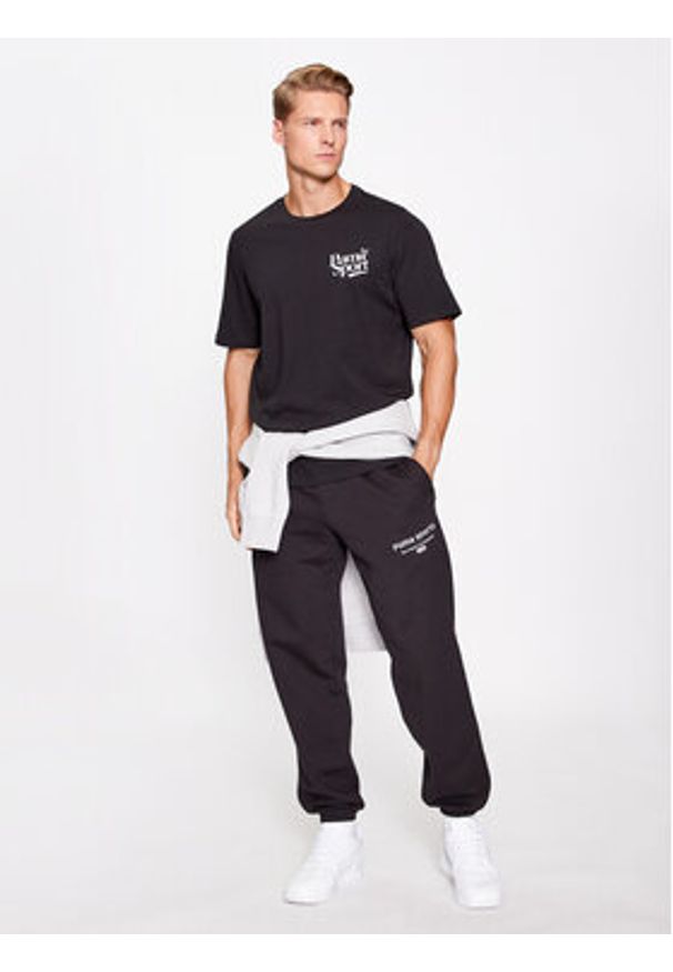Puma T-Shirt Graphics Legacy 622739 Czarny Regular Fit. Kolor: czarny. Materiał: bawełna