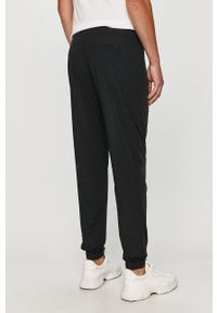 Calvin Klein Jeans - Spodnie. Kolor: czarny. Materiał: tkanina, poliamid, elastan. Wzór: nadruk #3