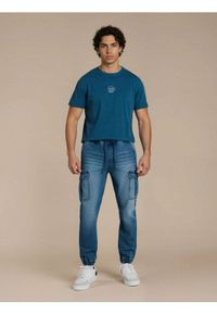 Sinsay - Jeansy jogger z efektem sprania - granatowy. Kolor: niebieski #1