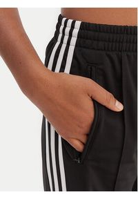 Adidas - adidas Spodnie dresowe Firebird KD7976 Czarny Loose Fit. Kolor: czarny. Materiał: syntetyk #2