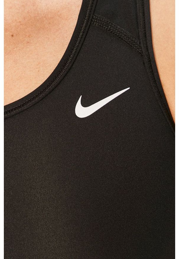 Nike - Biustonosz sportowy. Kolor: czarny. Materiał: włókno, skóra, tkanina. Rodzaj stanika: odpinane ramiączka. Technologia: Dri-Fit (Nike)