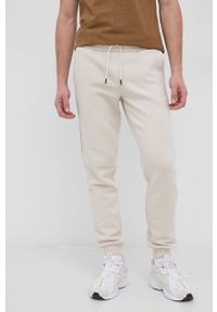 Jack & Jones Spodnie męskie kolor kremowy gładkie. Kolor: beżowy. Materiał: dzianina. Wzór: gładki