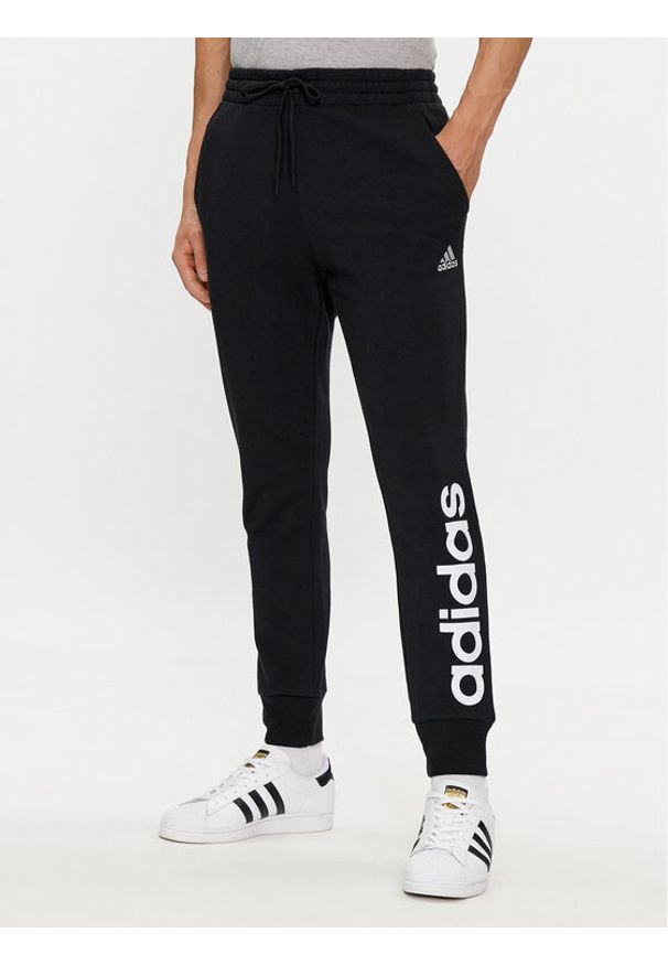 Adidas - adidas Spodnie dresowe Essentials French Terry Tapered Cuff Logo Joggers IC0063 Czarny Regular Fit. Kolor: czarny. Materiał: bawełna