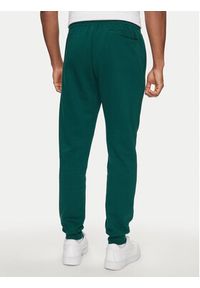 Adidas - adidas Spodnie dresowe Essentials IJ8892 Zielony Regular Fit. Kolor: zielony. Materiał: bawełna