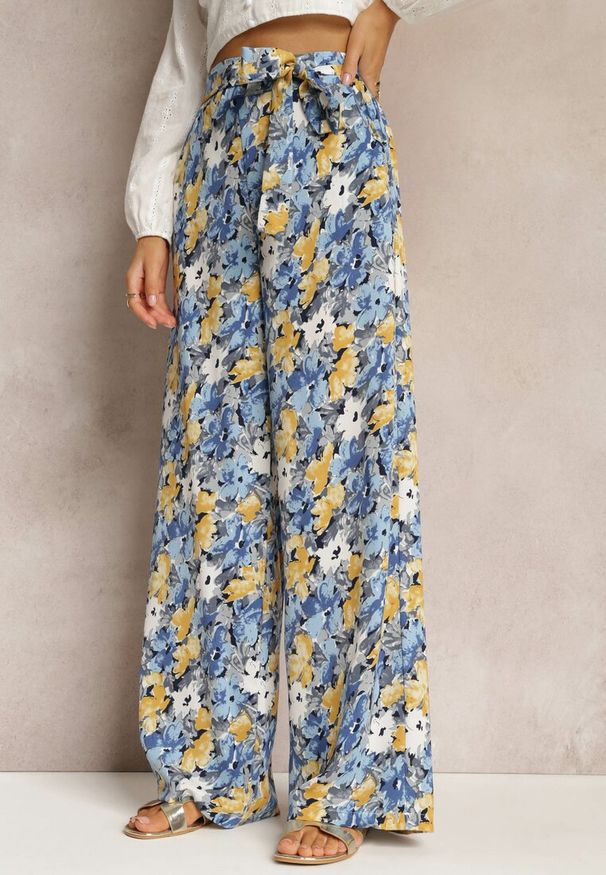 Renee - Niebieskie Długie Spodnie z Szerokimi Nogawkami oraz Kieszeniami i Materiałowym Paskiem Omina. Okazja: na plażę. Kolor: niebieski. Materiał: materiał. Długość: długie. Wzór: kwiaty, nadruk