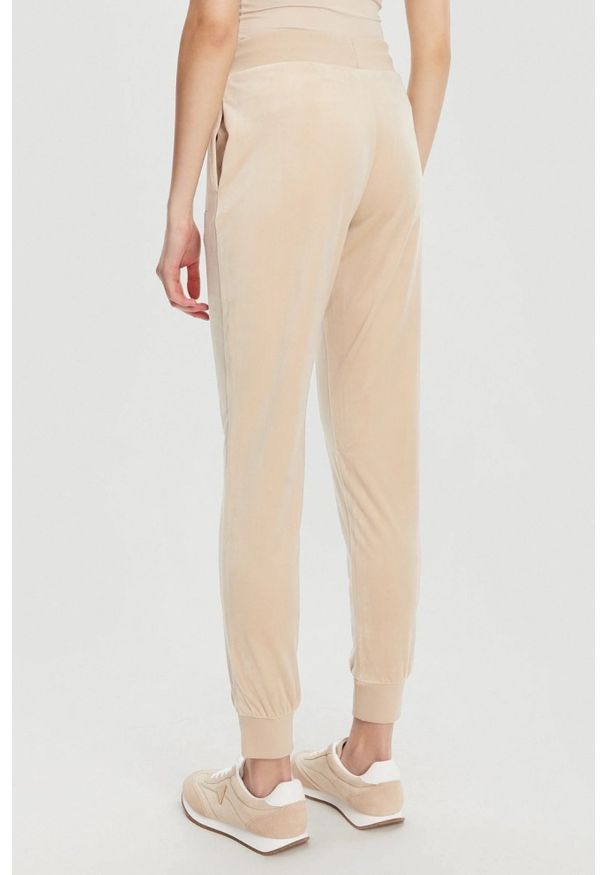 Guess - GUESS Beżowe damskie spodnie dresowe Couture, Rozmiar S. Kolor: beżowy. Materiał: dresówka