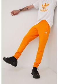 adidas Originals spodnie dresowe HG3902 męskie kolor pomarańczowy gładkie. Kolor: pomarańczowy. Materiał: dresówka. Wzór: gładki