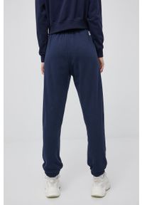 Champion spodnie 217404 kolor granatowy z aplikacją. Kolor: niebieski. Materiał: włókno, dzianina, materiał. Wzór: aplikacja #3
