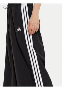 Adidas - adidas Spodnie dresowe Essentials 3-Stripes JE1306 Czarny Loose Fit. Kolor: czarny. Materiał: syntetyk #3