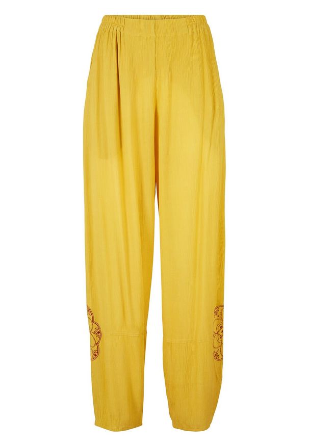 Spodnie z szerokimi nogawkami, wygodnym paskiem w talii i nadrukiem z boku bonprix żółty curry. Kolor: żółty. Wzór: nadruk