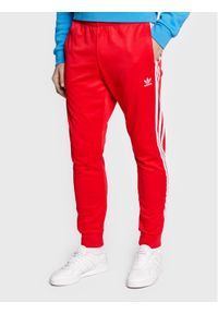 Adidas - adidas Spodnie dresowe adicolor Classics Primeblue HF2134 Czerwony Slim Fit. Kolor: czerwony. Materiał: bawełna, dresówka, syntetyk
