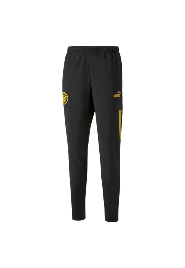 Puma - Spodnie przedmeczowe Manchester City 2022/23. Kolor: wielokolorowy, żółty, czarny. Sport: piłka nożna