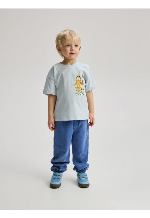 Reserved - Dresowe spodnie z efektem sprania - niebieski. Kolor: niebieski. Materiał: dresówka