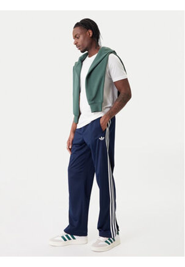 Adidas - adidas Spodnie dresowe Firebird KD8316 Granatowy Loose Fit. Kolor: niebieski. Materiał: syntetyk