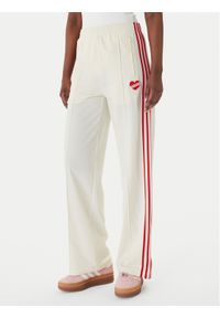 Adidas - adidas Spodnie dresowe Firebird KQ8056 Beżowy Loose Fit. Kolor: beżowy. Materiał: syntetyk #1