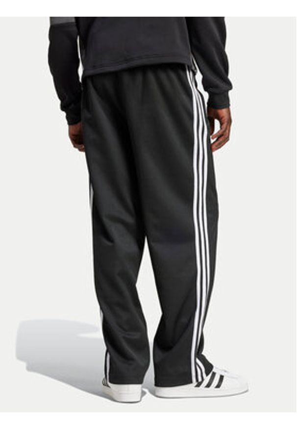 Adidas - adidas Spodnie dresowe adicolor Firebird IZ4801 Czarny Baggy Fit. Kolor: czarny. Materiał: syntetyk, bawełna