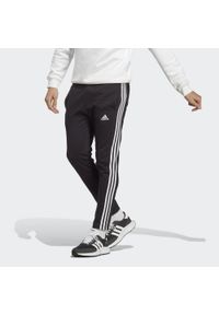 Adidas - Essentials Single Jersey Tapered Open Hem 3-Stripes Pants. Kolor: czarny, biały, wielokolorowy. Materiał: jersey. Sport: fitness #1