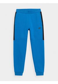 4f - Spodnie dresowe jogggery chłopięce. Okazja: na co dzień. Kolor: niebieski. Materiał: dresówka. Styl: casual #1