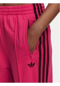 Adidas - adidas Spodnie dresowe Firebird Loose Tracksuit KW0228 Różowy Loose Fit. Kolor: różowy. Materiał: syntetyk #4