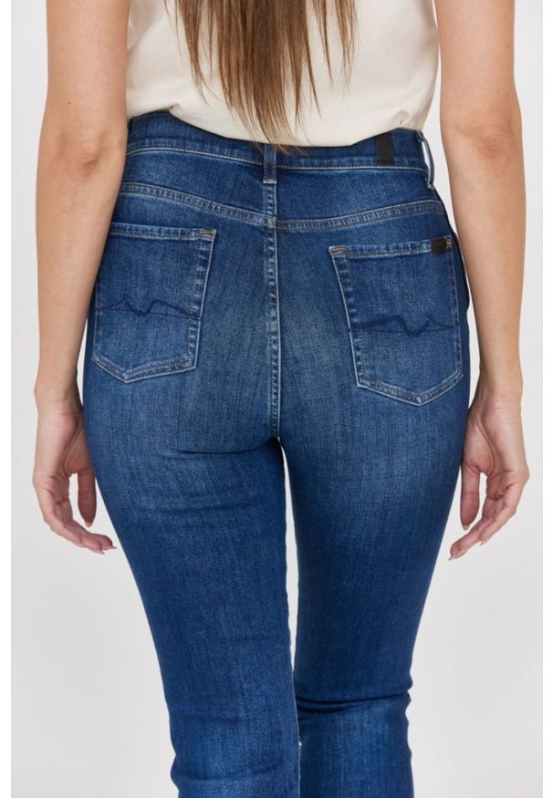 7 FOR ALL MANKIND Ciemnoniebieskie jeansy damskie z poszarpanymi nogawkami HW Slim Kick. Kolor: niebieski