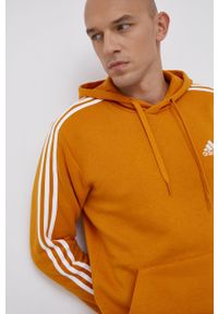 Adidas - adidas Bluza męska kolor pomarańczowy z kapturem gładka. Okazja: na co dzień. Typ kołnierza: kaptur. Kolor: pomarańczowy. Materiał: bawełna, dzianina, materiał. Wzór: gładki, aplikacja. Styl: casual