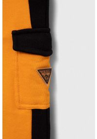 Guess spodnie dresowe bawełniane dziecięce kolor pomarańczowy wzorzyste. Stan: podwyższony. Kolor: pomarańczowy. Materiał: bawełna, dresówka #3