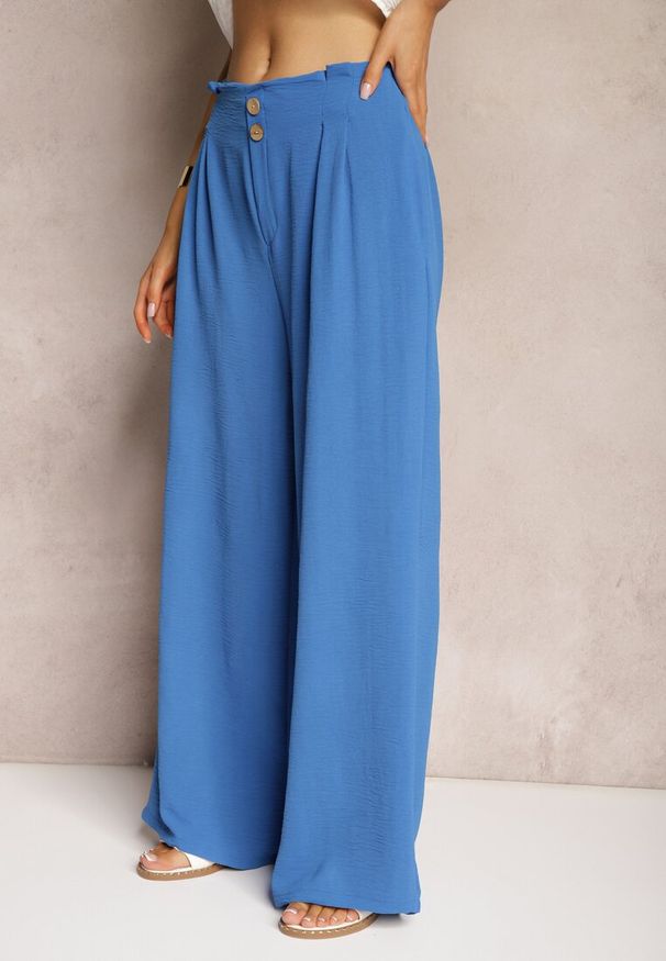 Renee - Niebieskie Spodnie w Stylu Alladynek High Waist Wykończone Gumką w Pasie Riselma. Okazja: na co dzień. Stan: podwyższony. Kolor: niebieski. Styl: casual, sportowy