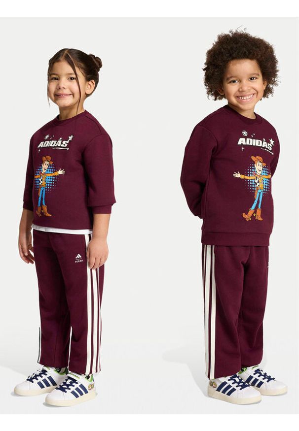 Adidas - adidas Spodnie dresowe Pixar Toy Story KG6131 Bordowy Regular Fit. Kolor: czerwony. Materiał: bawełna. Wzór: motyw z bajki