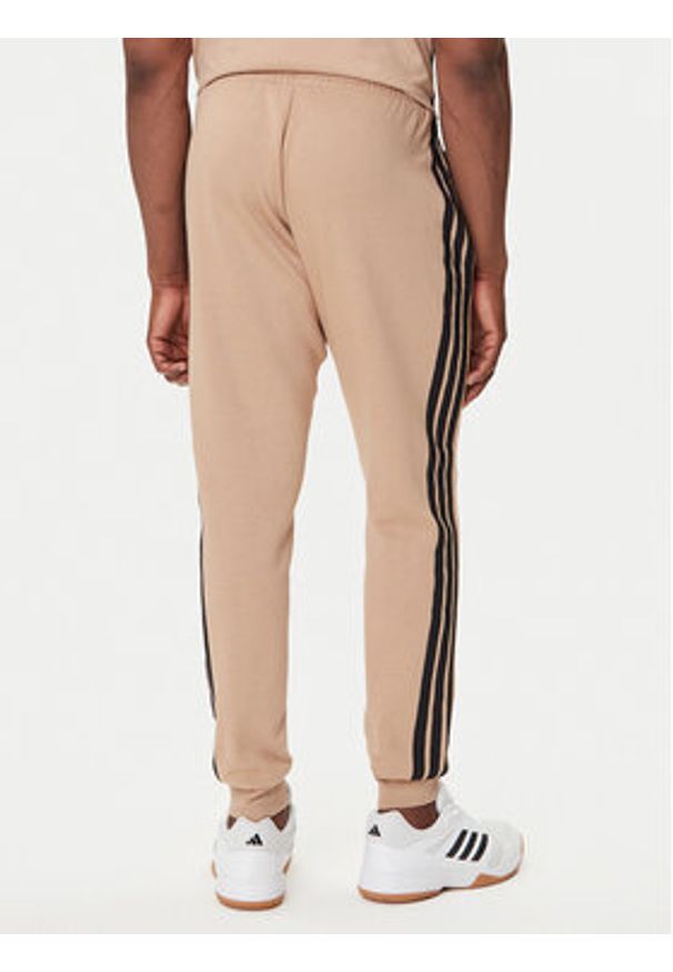 Adidas - adidas Spodnie dresowe Essentials 3-Stripes JX0712 Beżowy Regular Fit. Kolor: beżowy. Materiał: bawełna