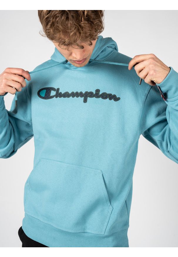 Champion Bluza "Hoodie" | HBGF89H586N9A | Mężczyzna | Błękitny. Okazja: na co dzień. Typ kołnierza: kaptur. Kolor: niebieski. Materiał: bawełna, poliester. Wzór: aplikacja. Styl: casual