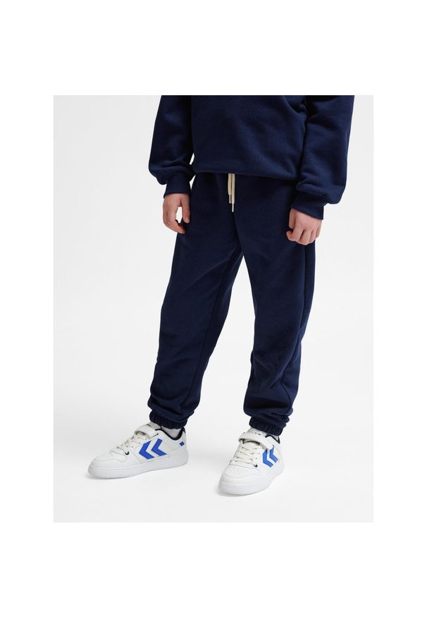 Spodnie dresowe dla dzieci Hummel Bee Loose. Kolor: wielokolorowy, niebieski, zielony. Materiał: dresówka. Sport: joga i pilates