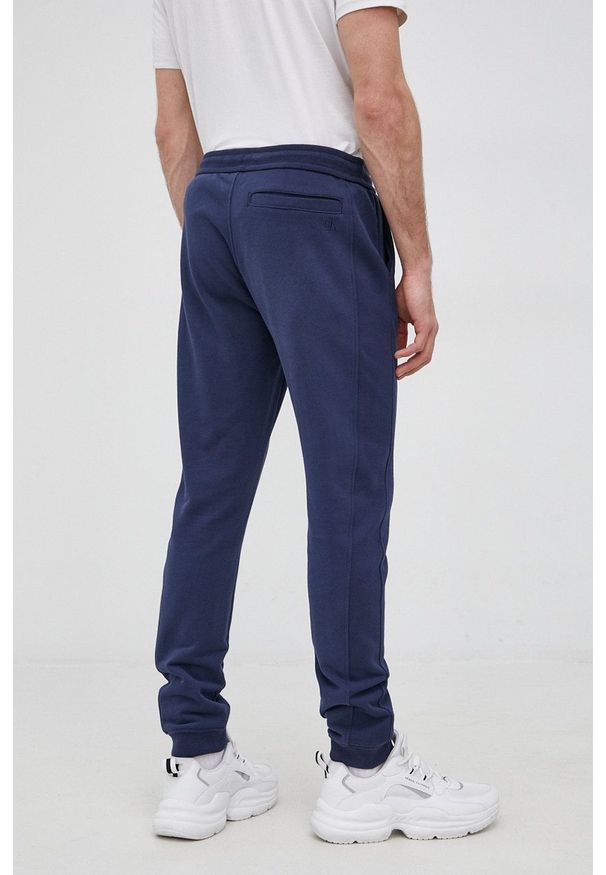 Calvin Klein Jeans Spodnie bawełniane męskie kolor granatowy gładkie. Kolor: niebieski. Materiał: bawełna. Wzór: gładki