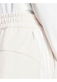 Adidas - adidas Spodnie dresowe Train Essentials IS3969 Różowy Loose Fit. Kolor: różowy. Materiał: syntetyk