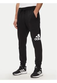 Adidas - adidas Spodnie dresowe Essentials French Terry Tapered Cuff Logo Joggers HA4342 Czarny Regular Fit. Kolor: czarny. Materiał: bawełna #1