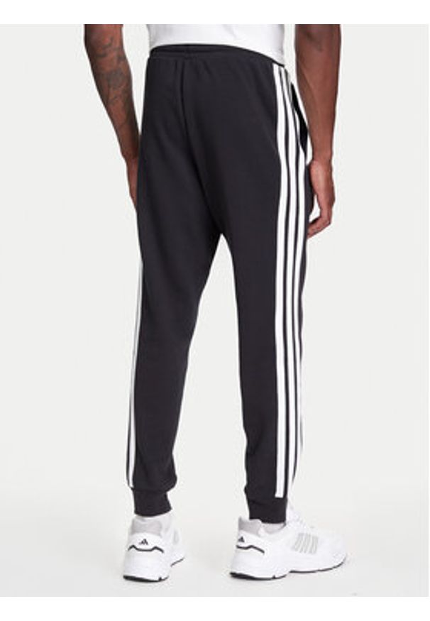 Adidas - adidas Spodnie dresowe Essential 3-Stripes JD1881 Czarny Regular Fit. Kolor: czarny. Materiał: bawełna, syntetyk