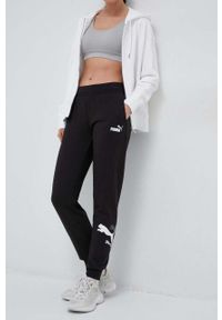 Puma spodnie dresowe kolor czarny z nadrukiem. Kolor: czarny. Materiał: dresówka. Wzór: nadruk #1