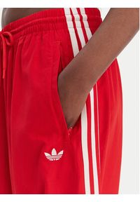 Adidas - adidas Spodnie dresowe Firebird Adilenium KD6299 Czerwony Regular Fit. Kolor: czerwony. Materiał: syntetyk #2