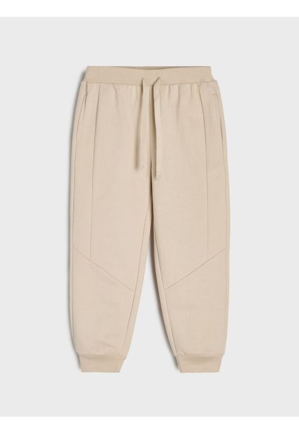 Sinsay - Spodnie dresowe jogger - beżowy. Kolor: beżowy. Materiał: dresówka