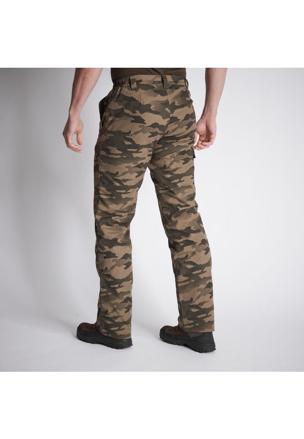 SOLOGNAC - Spodnie Warm 100 camo haltfone. Kolor: beżowy. Materiał: materiał