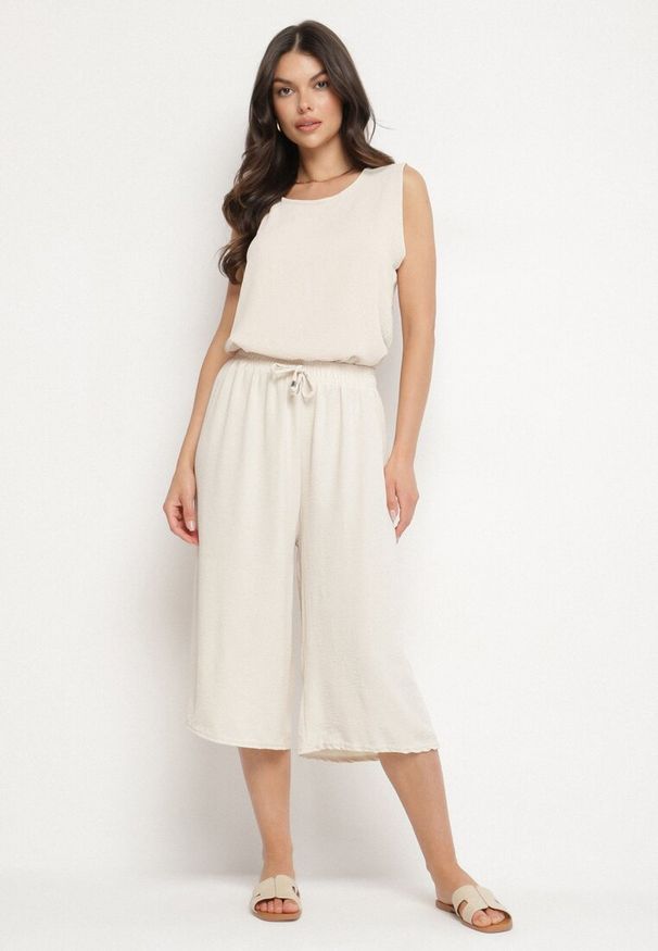 Born2be - Beżowe Szerokie Spodnie Typu Kuloty z Bawełną i Wysokim Stanem Talivelle. Okazja: na co dzień. Stan: podwyższony. Kolor: beżowy. Materiał: bawełna. Styl: casual, elegancki