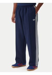 Adidas - adidas Spodnie dresowe adicolor Spacer Track KD4087 Granatowy Baggy Fit. Kolor: niebieski. Materiał: syntetyk. Sport: turystyka piesza