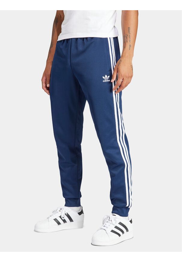 Adidas - adidas Spodnie dresowe adicolor Classics SST IR9887 Granatowy Slim Fit. Kolor: niebieski. Materiał: bawełna, syntetyk