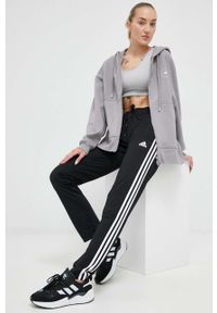 Adidas - adidas spodnie dresowe kolor czarny z aplikacją. Kolor: czarny. Materiał: dresówka. Wzór: aplikacja #1